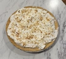 Homemade coconut cream pie, representing the practice of slowing down and being present in the kitchen during the holidays.